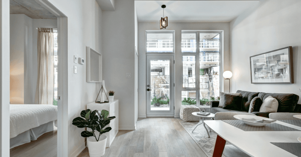 An apartment with floor-to-ceiling glass windows and white walls